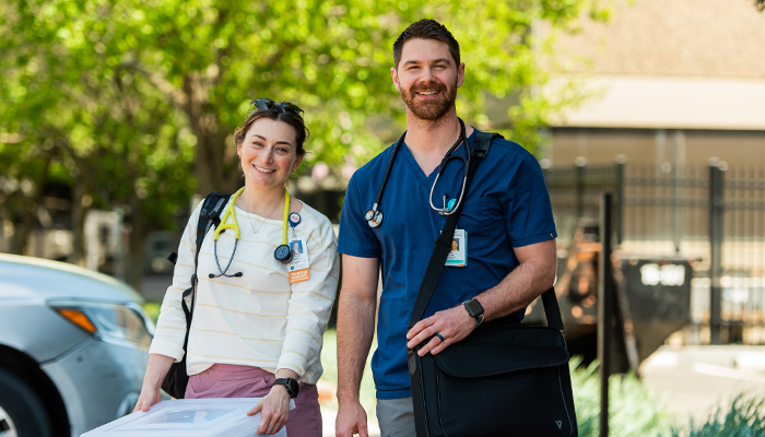 Tow medical workers standing outside