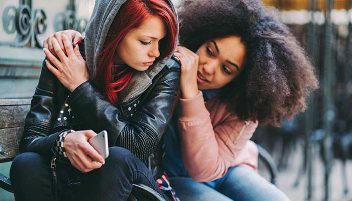 Two teens side by side