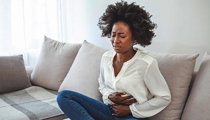 Woman clutching her stomach