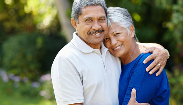 Senior man hugging senior woman outdoors
