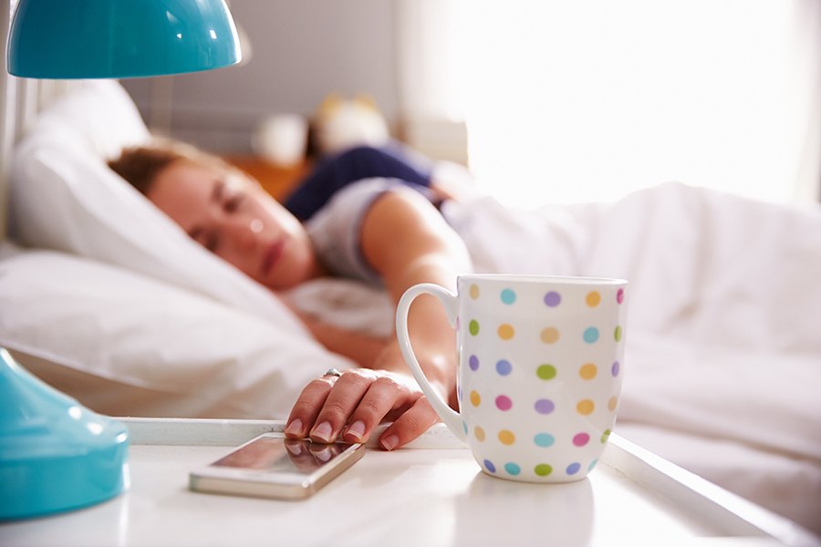 Image of woman hitting snooze button