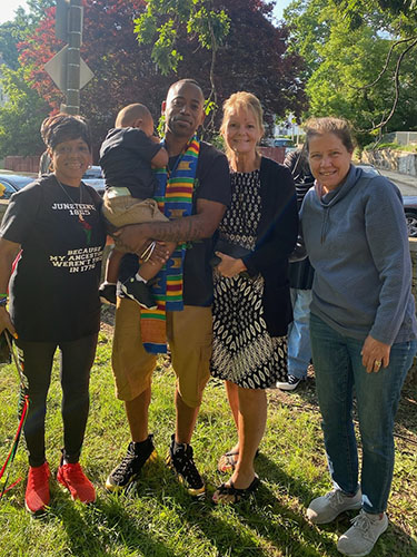 Anthony Gray standing with Ms. Maida and Kathy Gill and Robin Norberg.