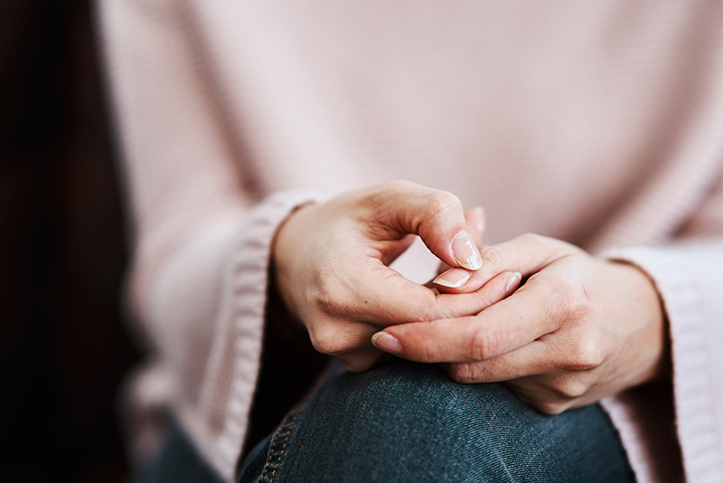 Closeup of woman wringing hands