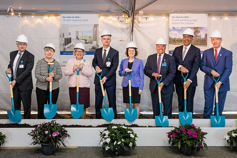 Members of BWFH Leadership wearing hardhats and holding shovels