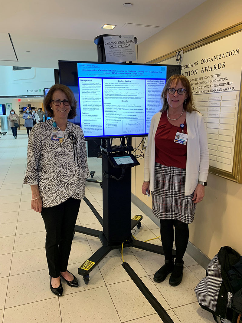 Helene Bowen Brady and Kathleen Lang standing with poster