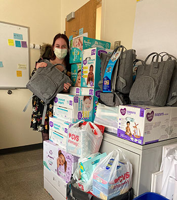 BWFH Emerging Leaders co-chair Katie Plante with the group's Diaper Drive collection.