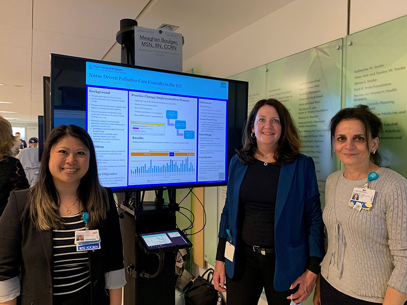 Meigan Amaral, Ellen McCarthy and Estier Sayegh standing with poster