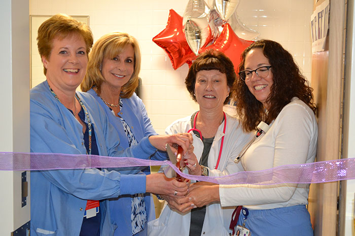 Staff celebrating Pre-Op Holding's new patient restroom