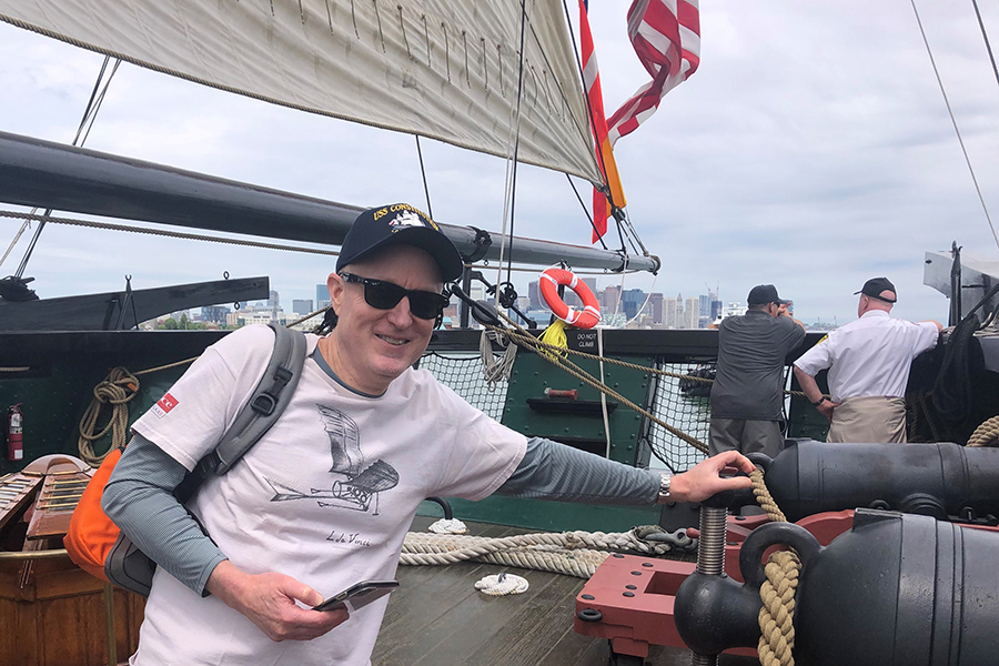 Roger Clark standing next to cannon on USS Constitution