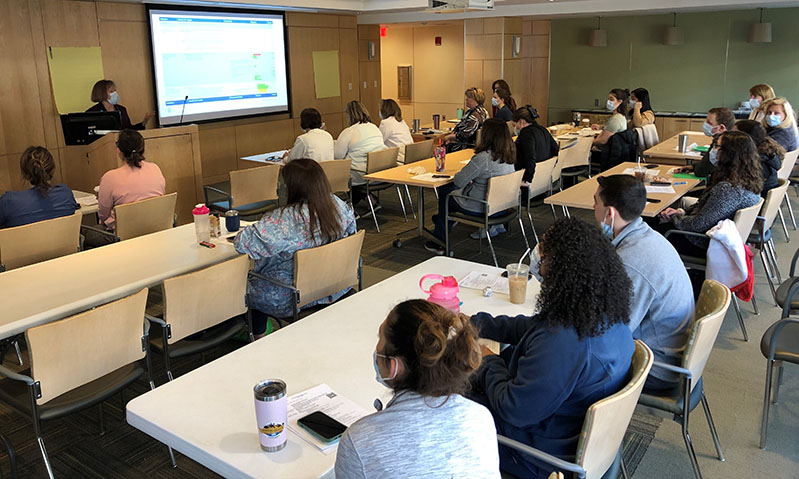 Nurses in a conference room  attending the spring summit 